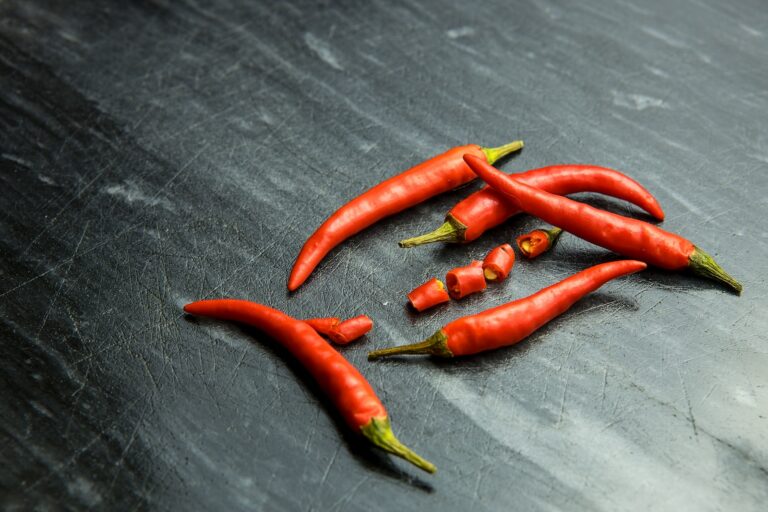 a group of red hot peppers sitting on top of a table